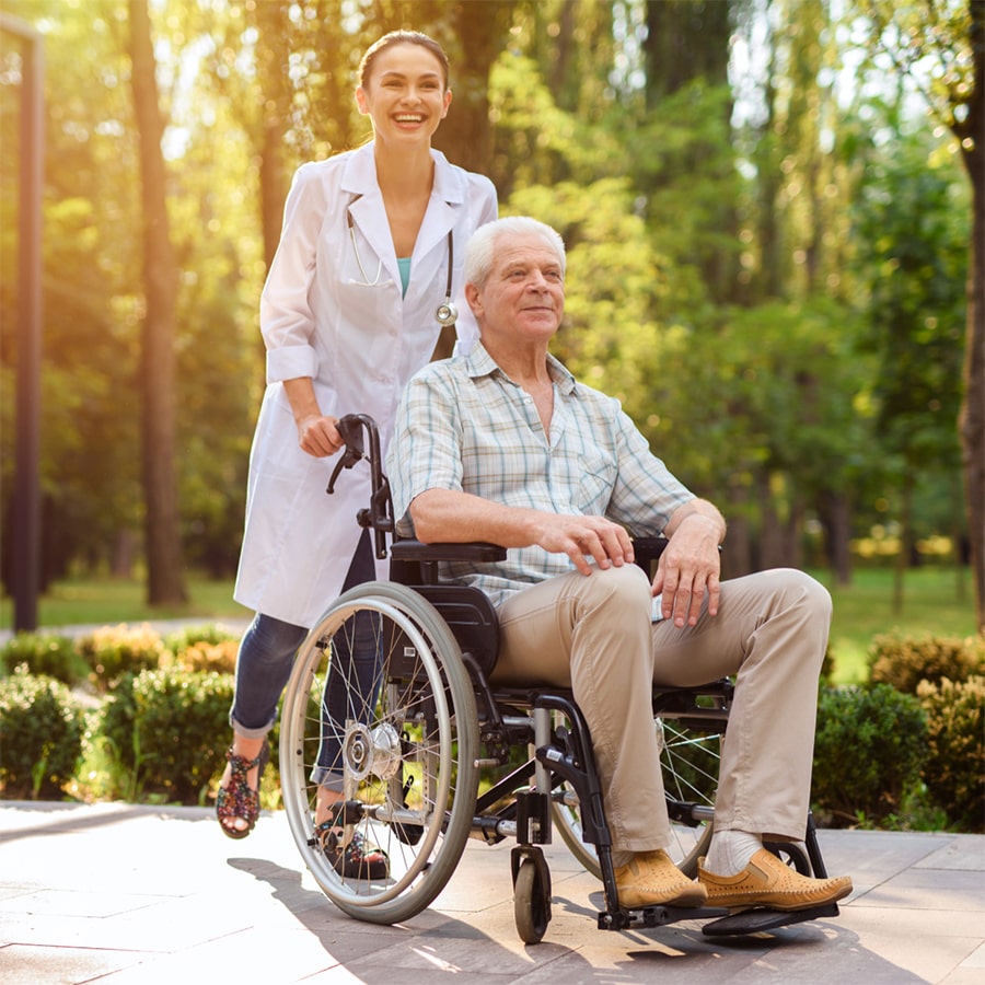 Nurse Helping Elderly Disabled mAN